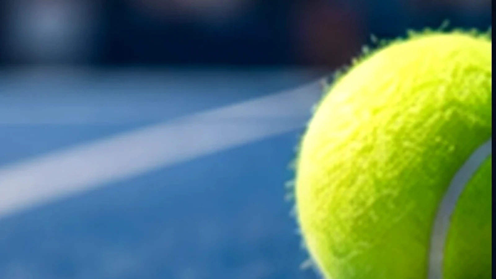 Pelota de tenis sobre pista azul
